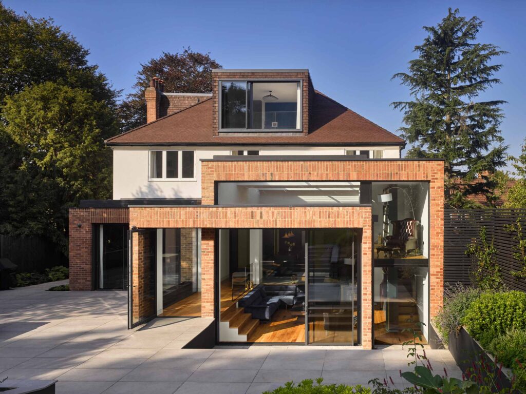 Rear view of Bookcase House showing its brick extension and glazed doors
